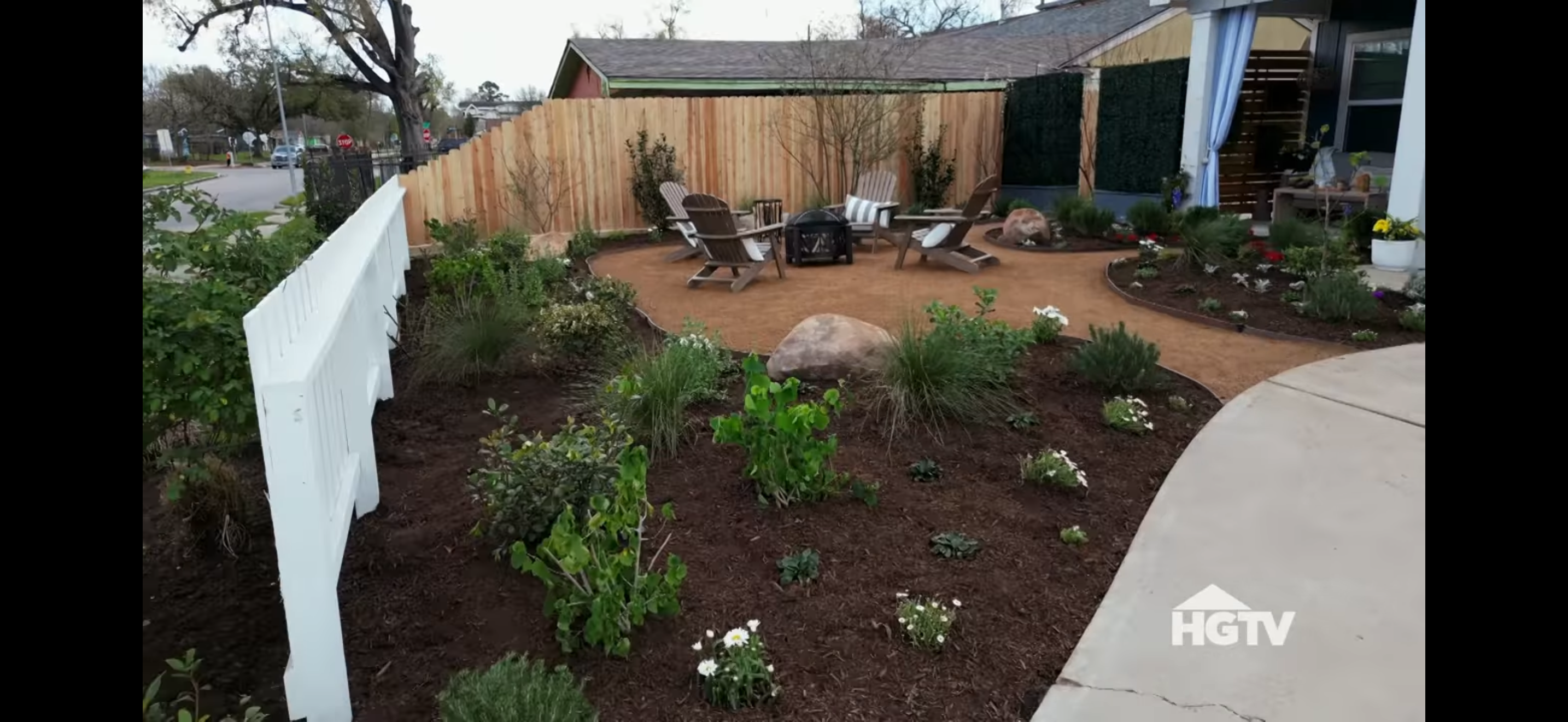 A close up shot of the front yard of a home from HGTV's Worst Yard on the Block