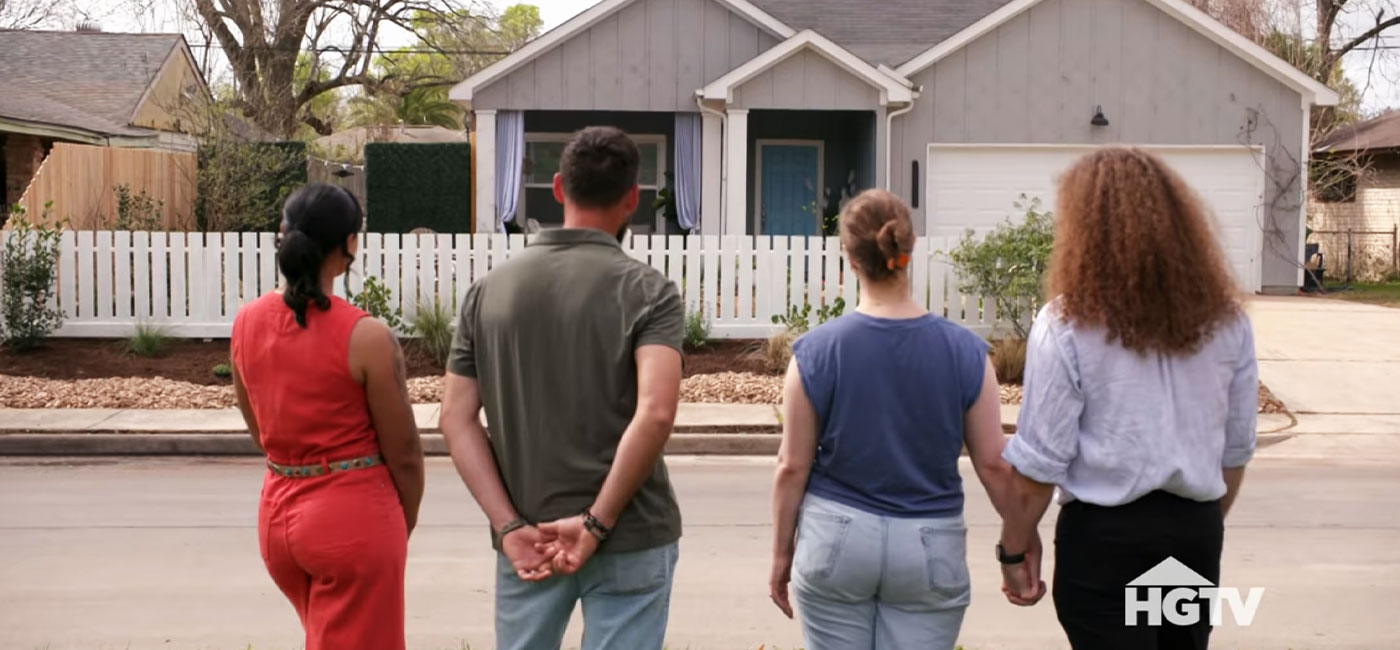 A Houston family and HGTV professionals gazing at a 76 Fence West Houston installed horizontal privacy fence on HGTV's Worst Yard on the Block.