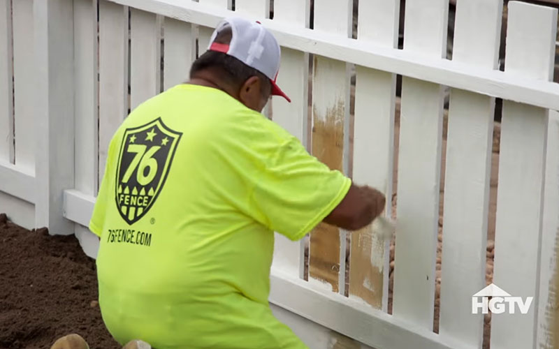 A 76 Fence technician expertly installing a fence for a Houston family on HGTV's Worst Yard on the Block