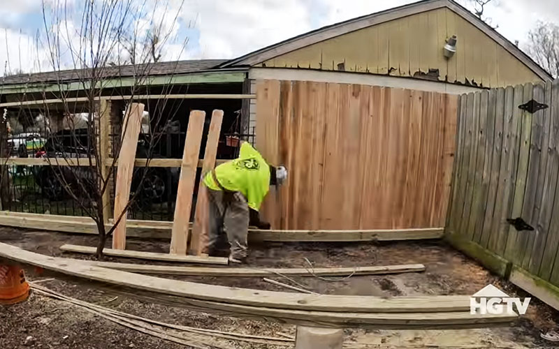 The 76 Fence team expertly installing a fence for a Houston family on HGTV's Worst Yard on the Block