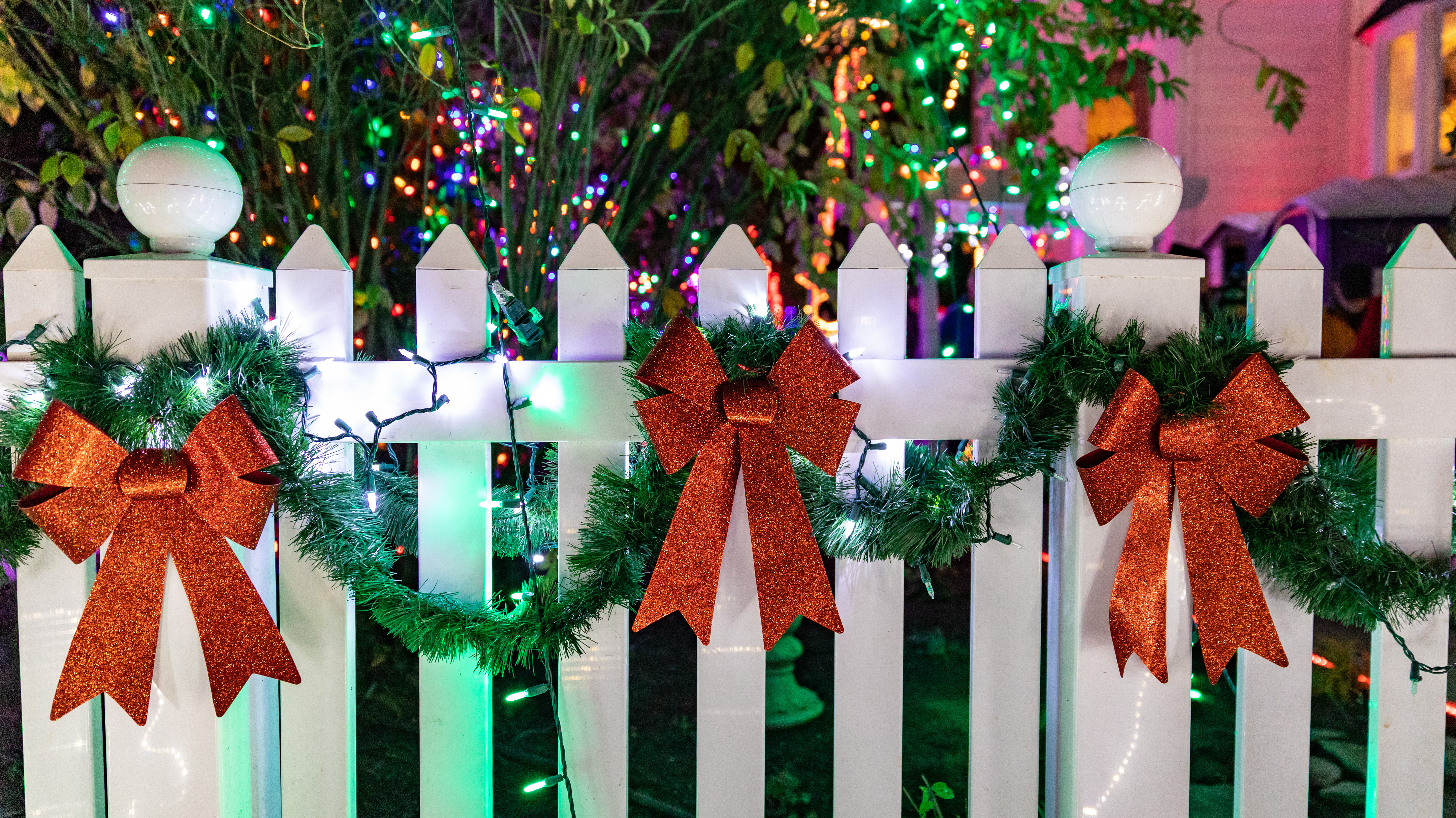 A fence stylishly decorated for the holidays - read about outdoor holiday decorating ideas with 76 FENCE. 