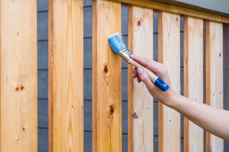 A fence with new weather coating applied by a team member from 76 FENCE Concord