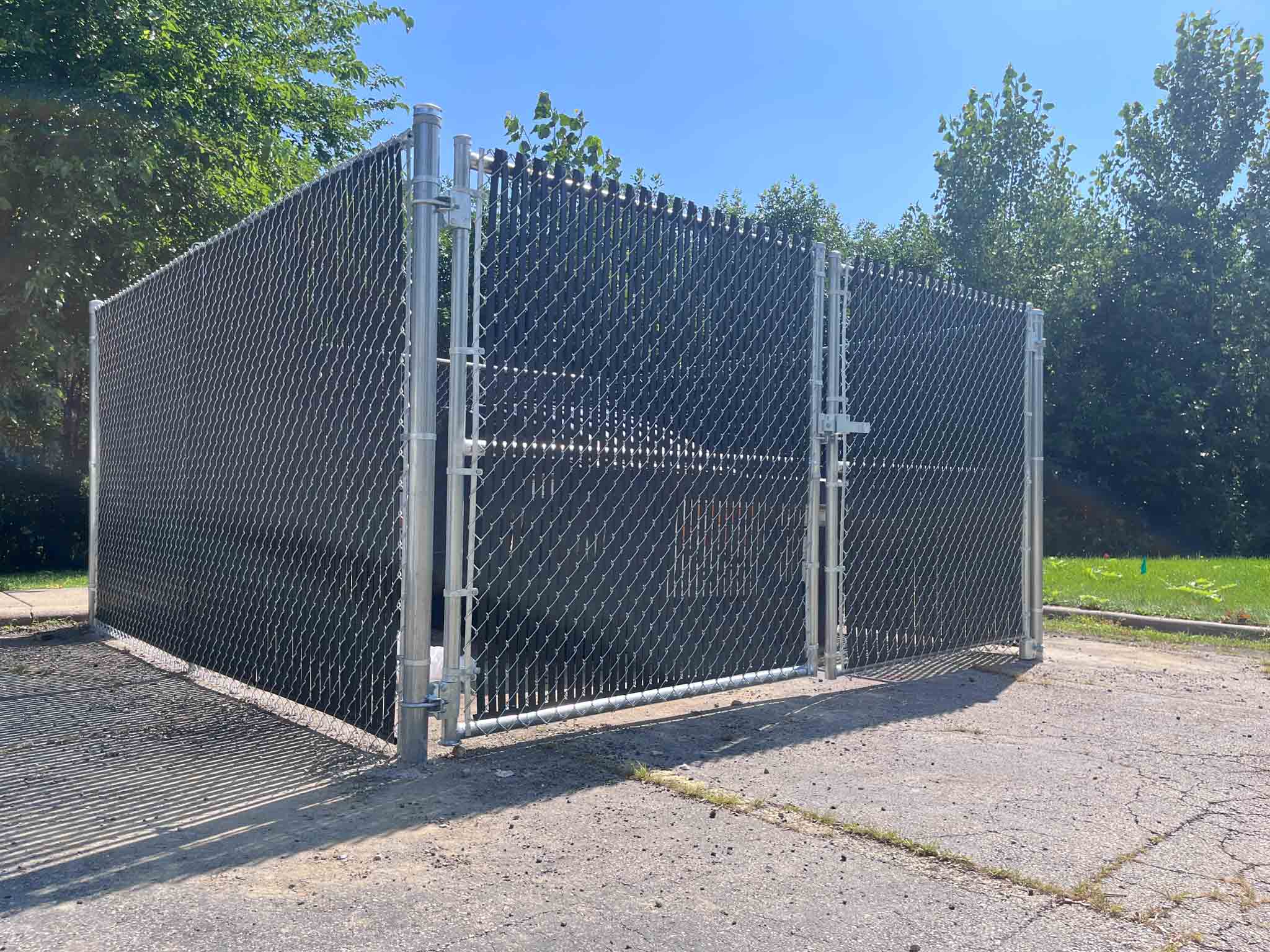 A 76 FENCE Mt. Juliet commercial fence company working on a dumpster enclosure.