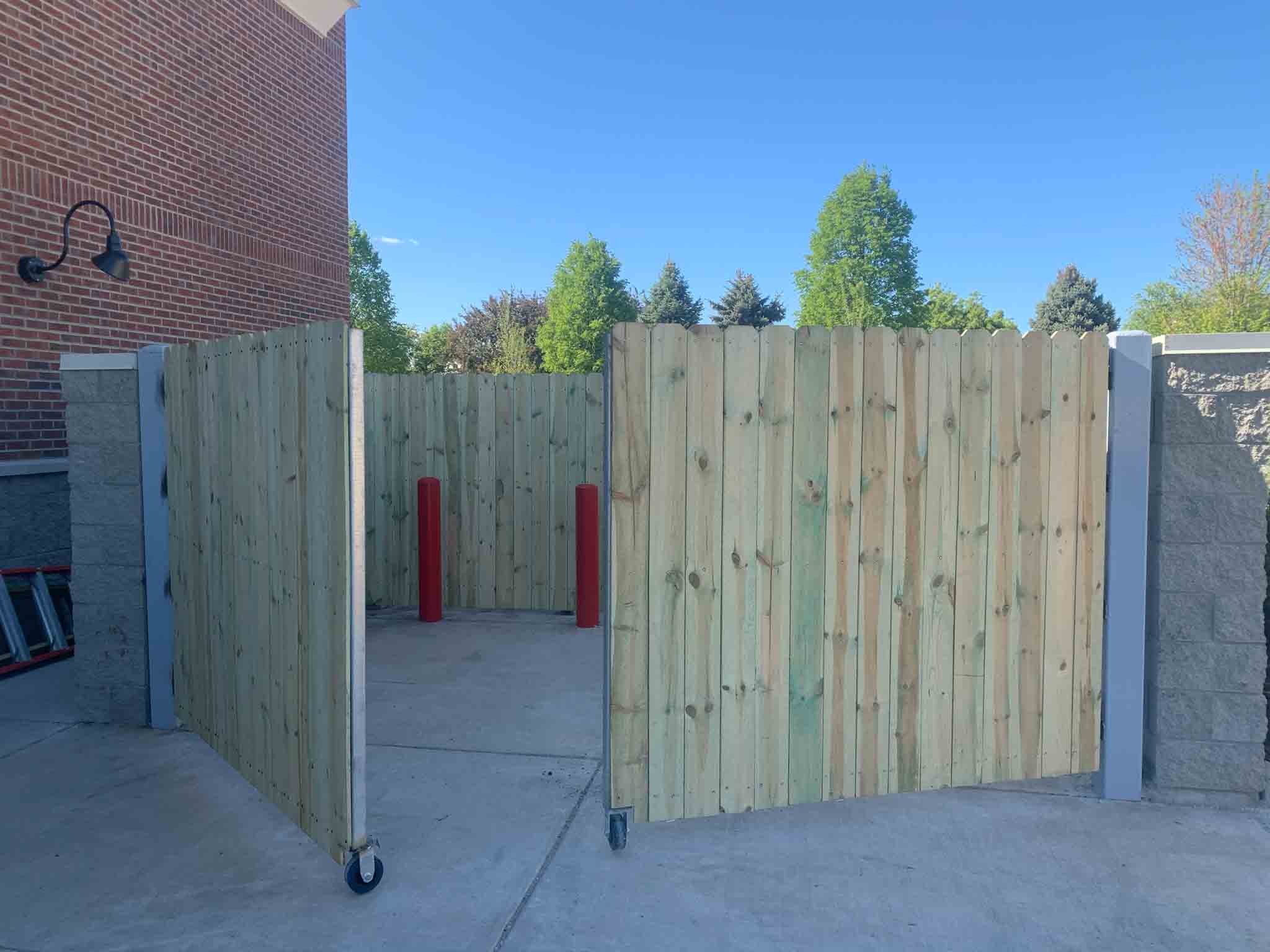 A wood commercial dumpster enclosure gate in Charlotte, NC.