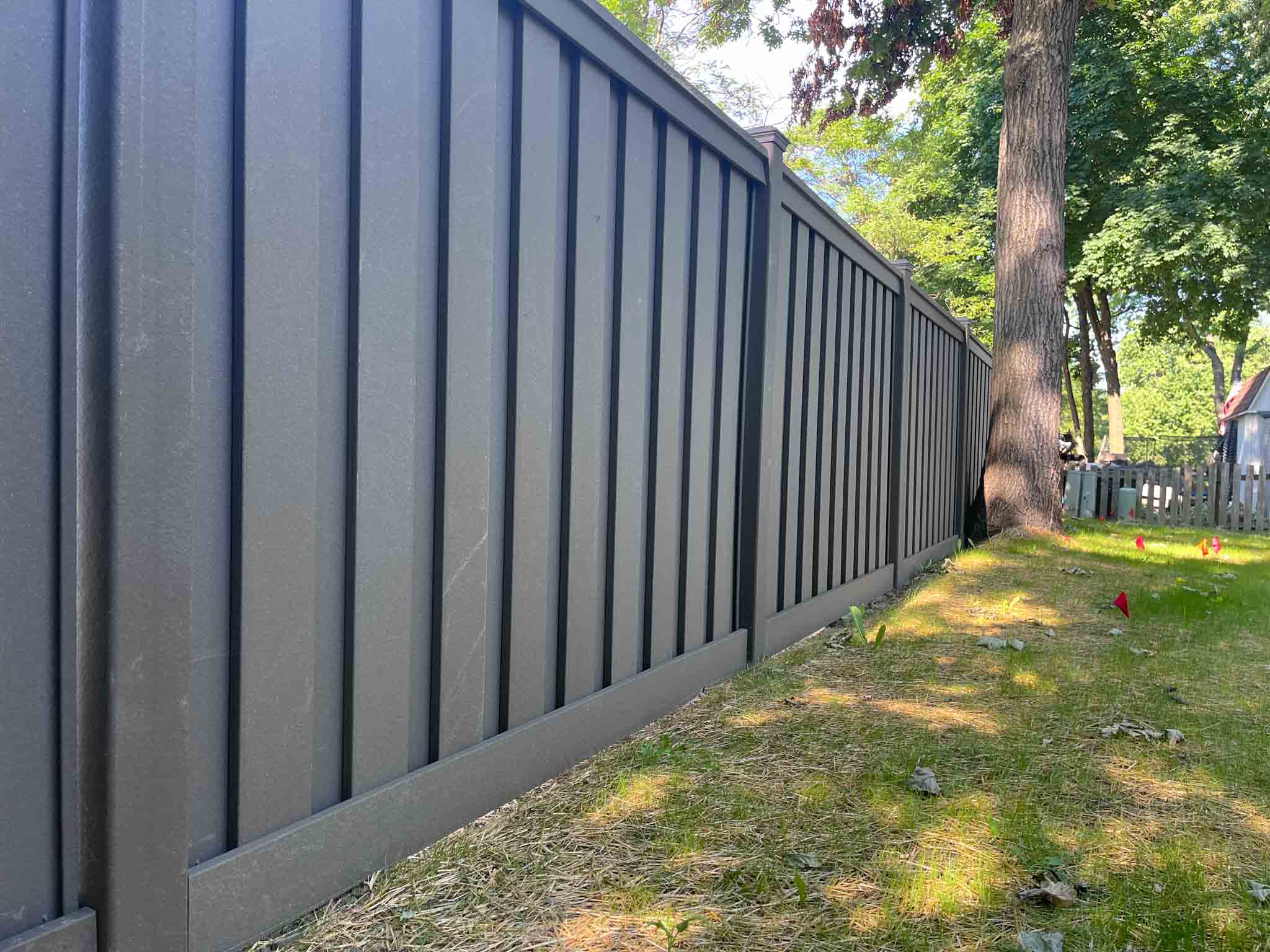 A close up of a composite fence installed by the team at 76 FENCE Schaumburg.