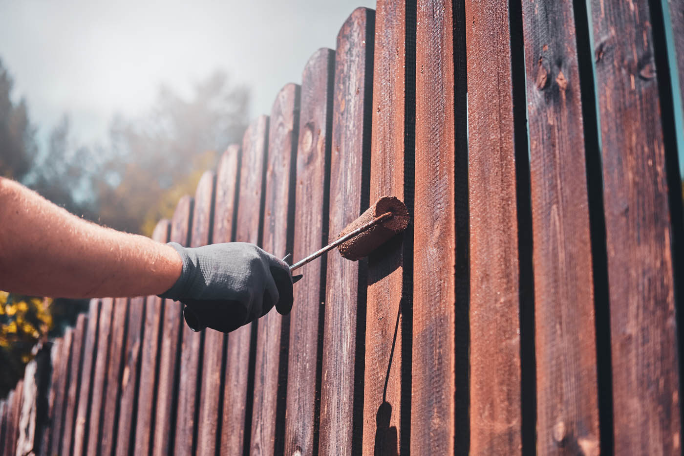 A 76 FENCE technician working on fence maintenance services in Charlotte, NC.