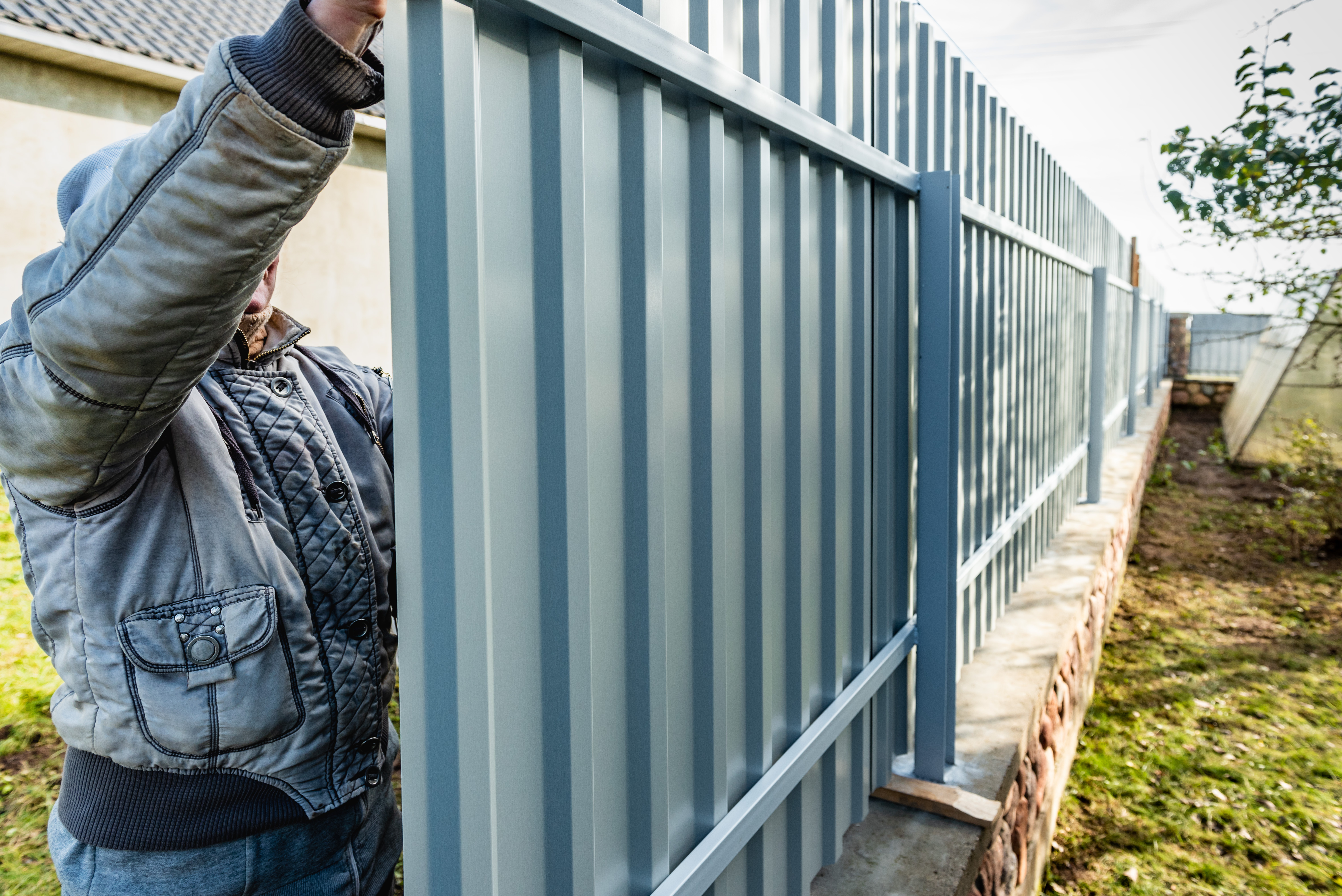 A 76 FENCE North Nashville team member installing an industrial steel fence.