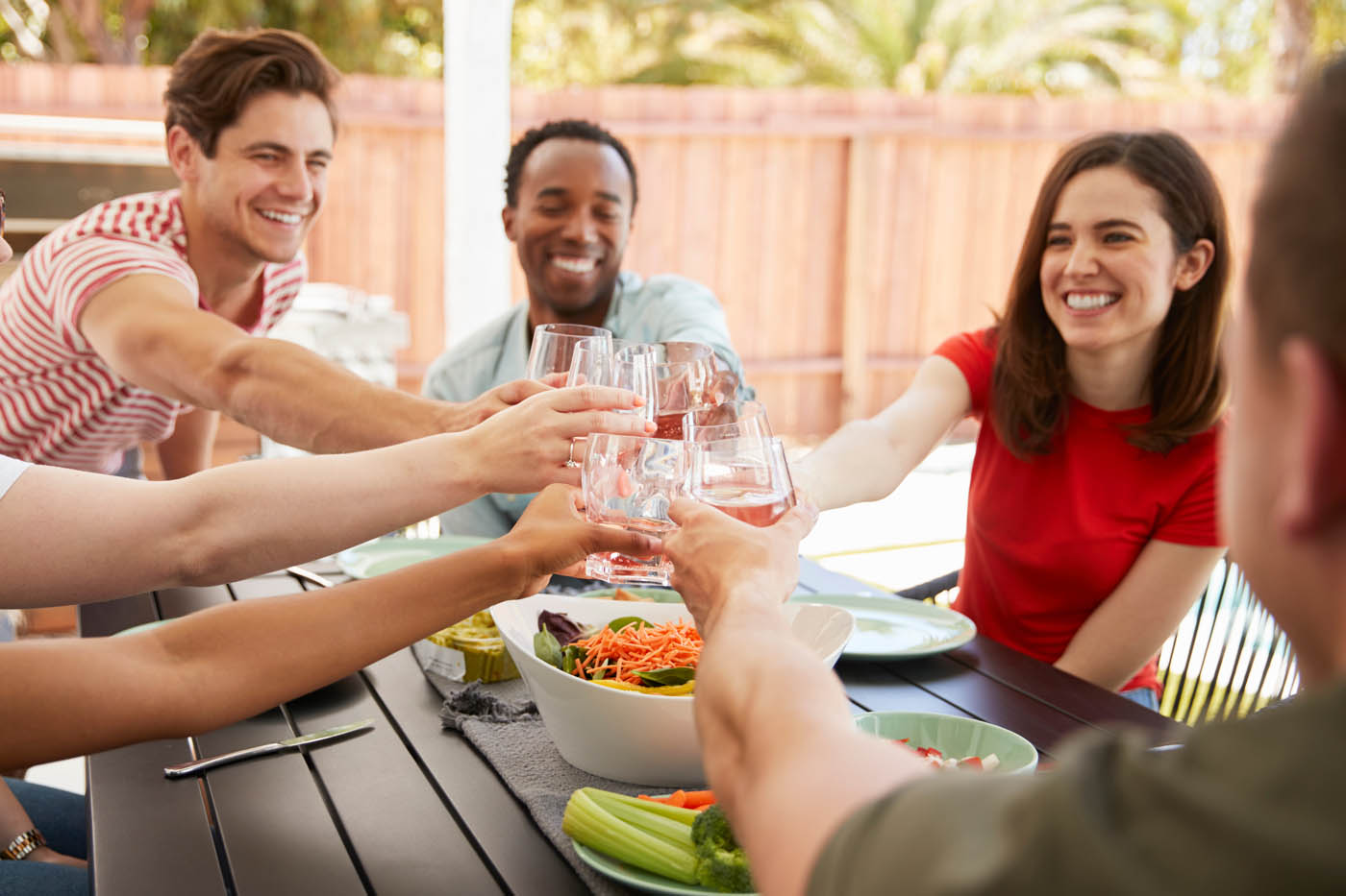 A group of friends and family enjoying their backyard space.