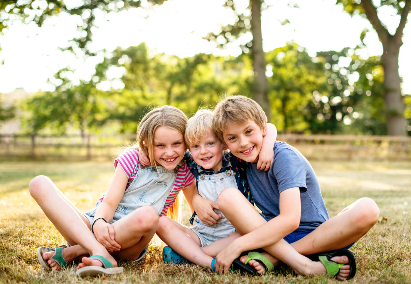 A group of kids in their yard - 76 FENCE provides fencing services to enhance your families safety and aesthetic appeal of your property.