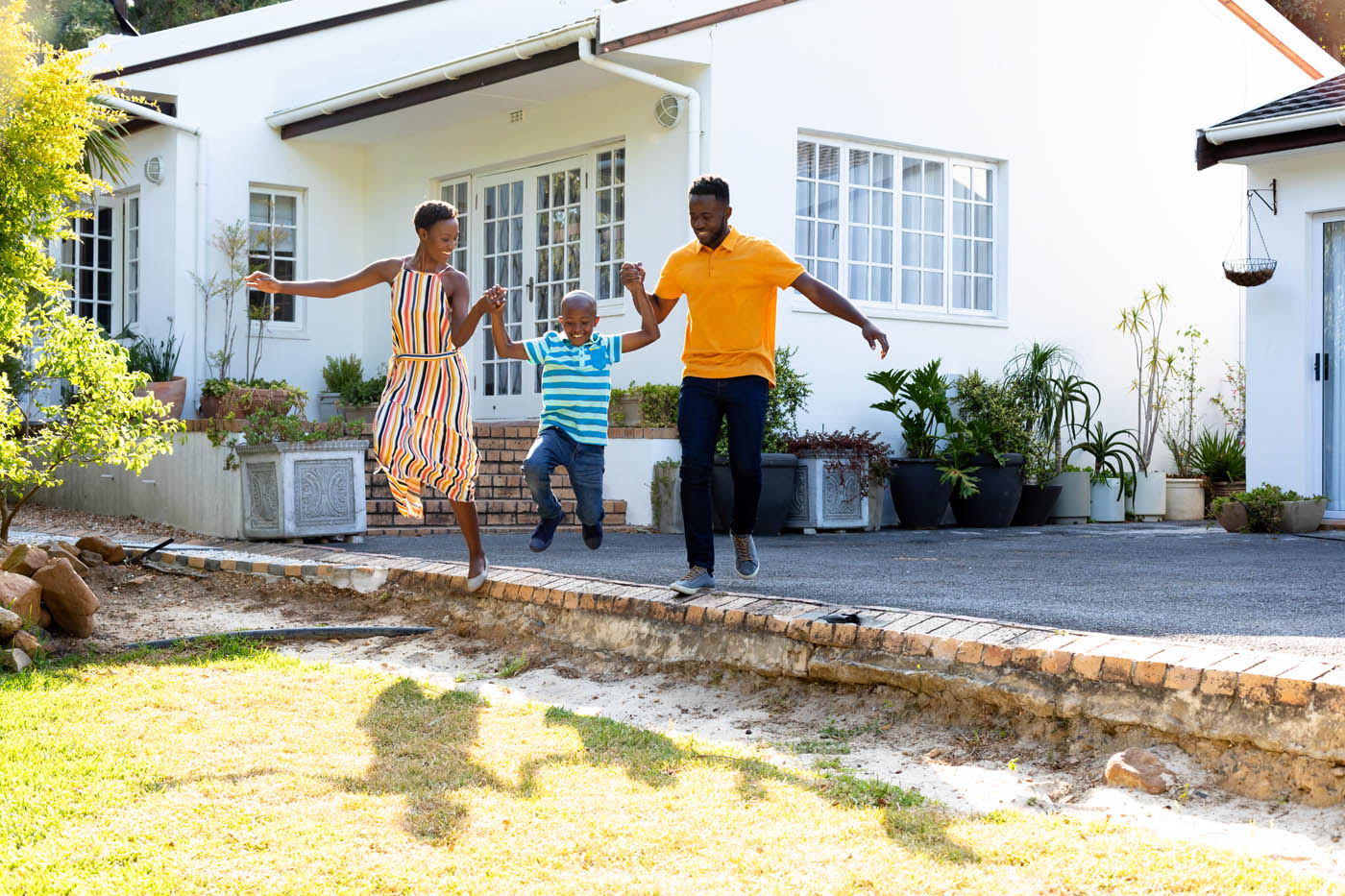 A family playing in their backyard - trust 76 FENCE to protect your home with a Murfreesboro / Franklin housing fence.