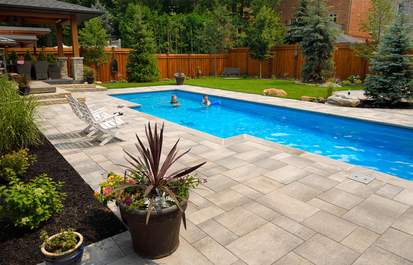 A beautiful pool on a residentail property - hire a swimming pool fence company like 76 FENCE to keep everyone safe.