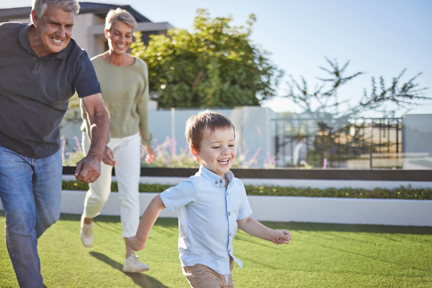 A young child running in his back yard with a new fence installation provided by 76 FENCE fence company.