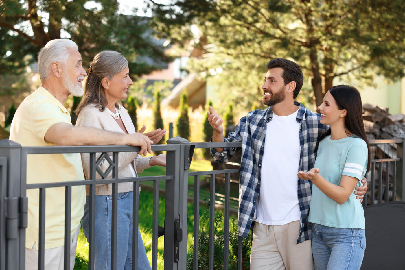 Neighboors chatting over their fence - if you need HOA fencing, trust the 76 FENCE experts.