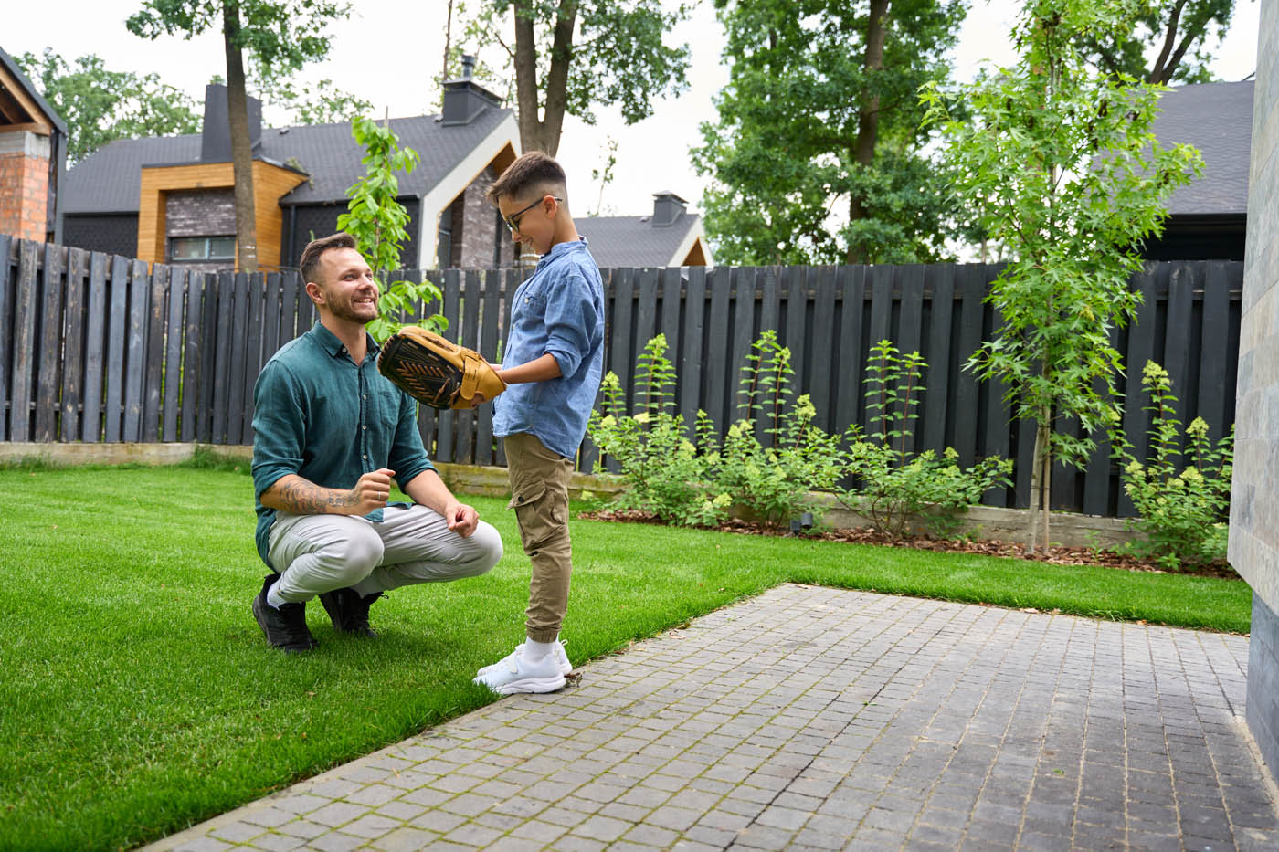 A dad and boy playing in their yard - experience the best residential fencing solutions in Murfreesboro / Franklin, TN with 76 FENCE.