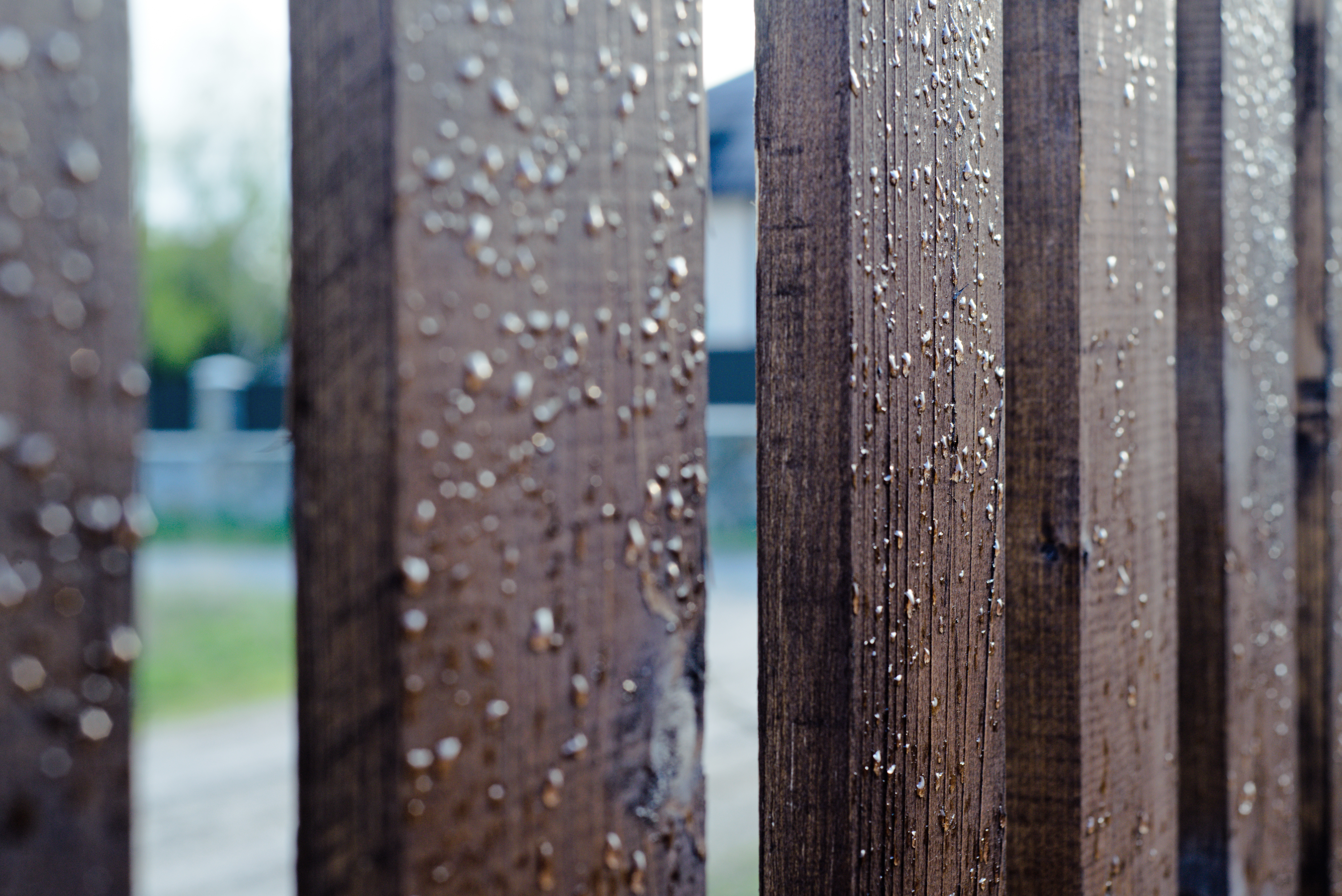 A fence with a protective weather coating withstanding rainy weather.