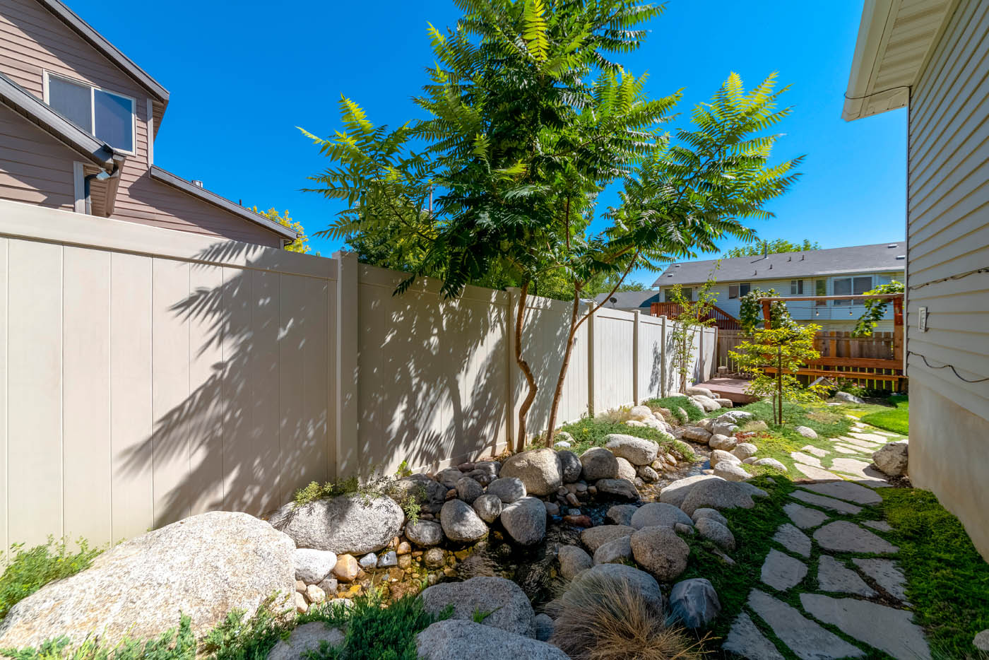 A vinyl fence installed on a residential property.