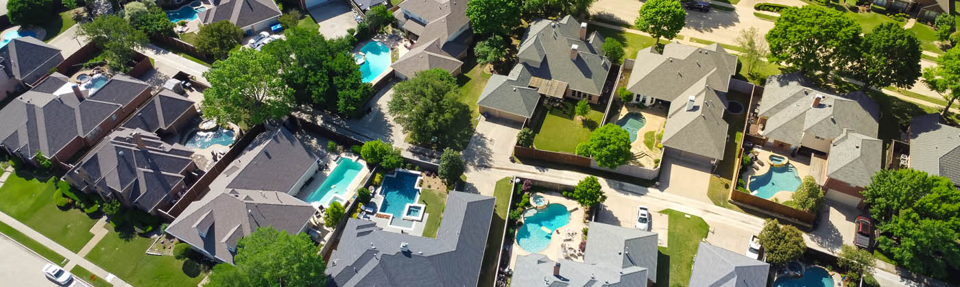 A backyard residential neighborhood with pool fences.