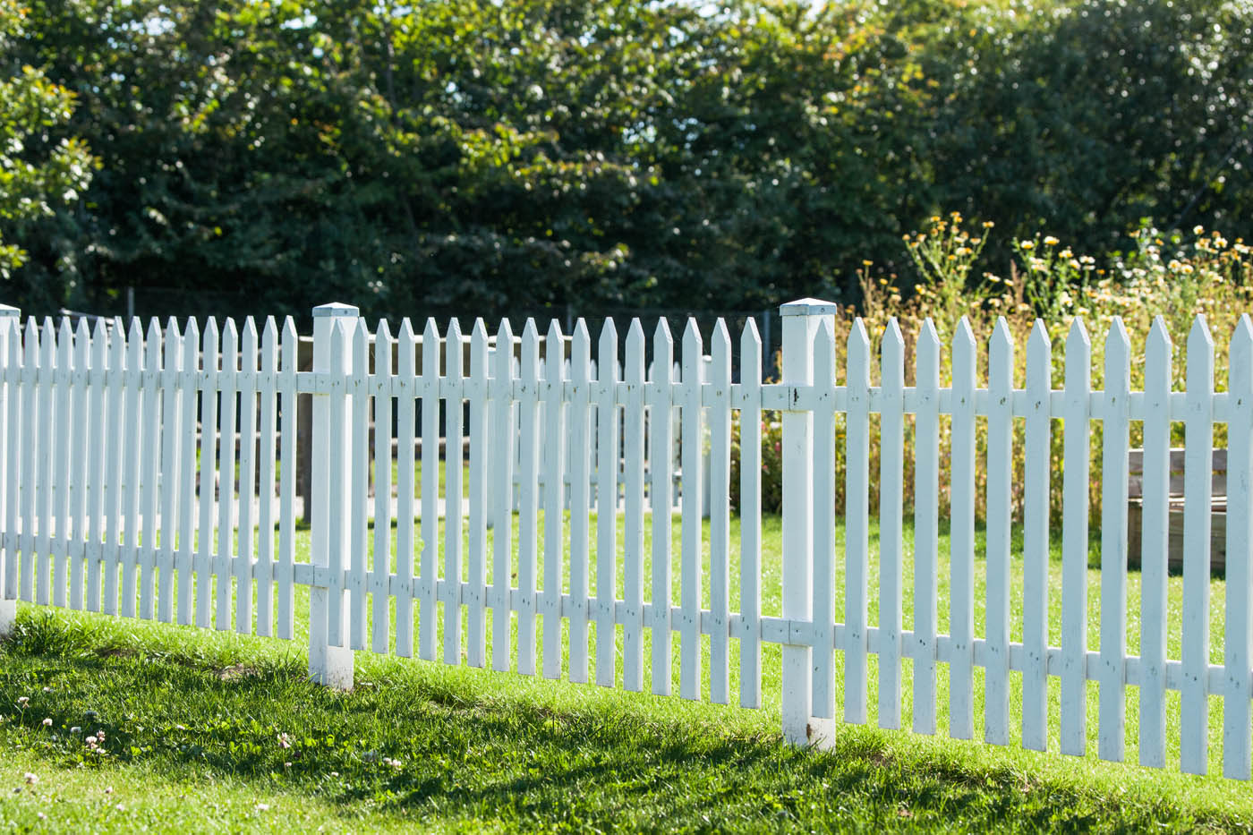 A sleek, clean fence fresh from pressure washing - contact 76 FENCE today to disucss our pressure washing services.