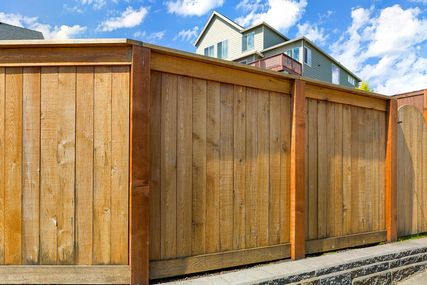 A durable light wooden fence installed by the experts at 76 FENCE North Charlotte.