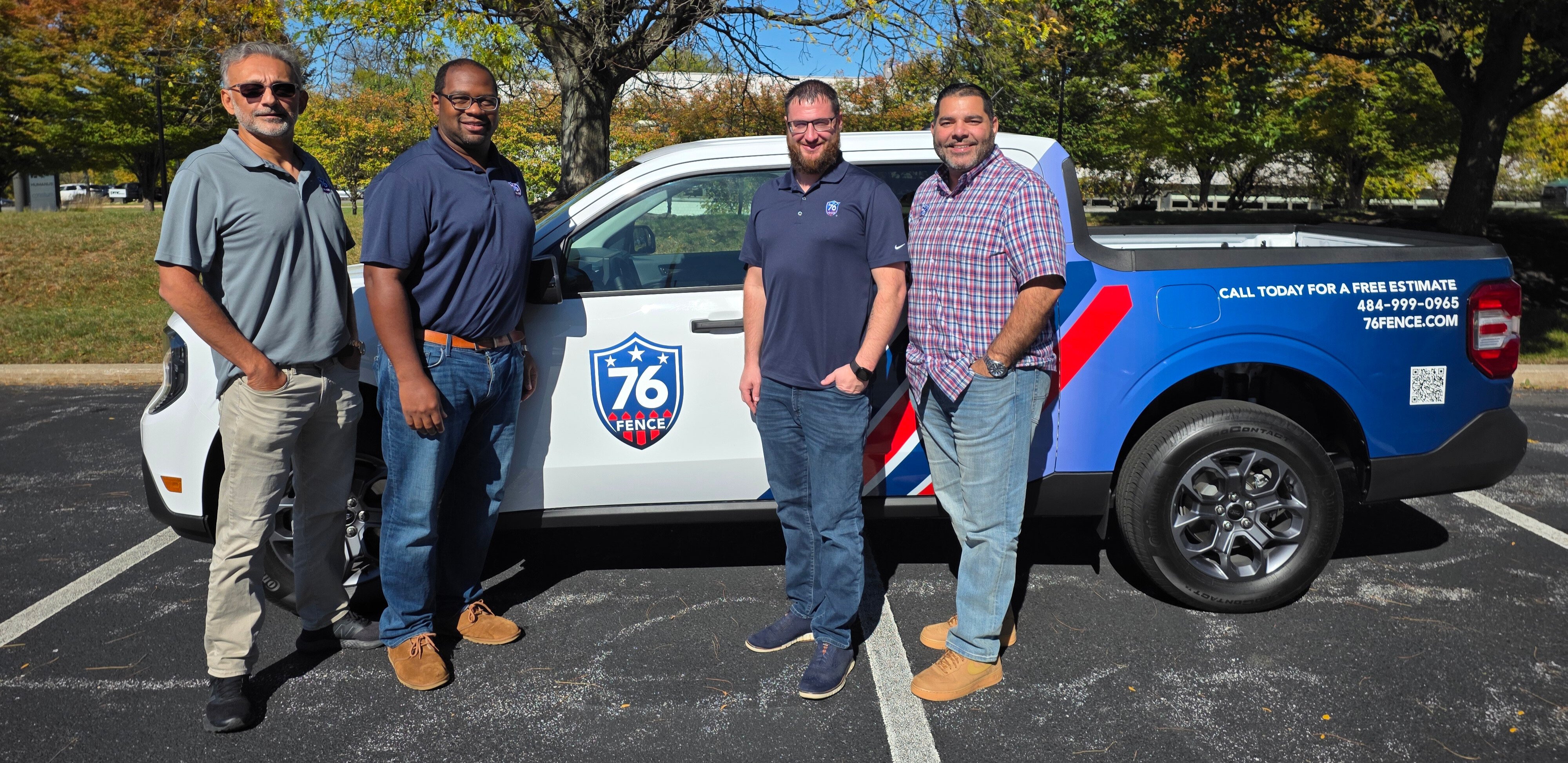 76 Fence Main Line owners standing by a truck, provided by our fencing company.