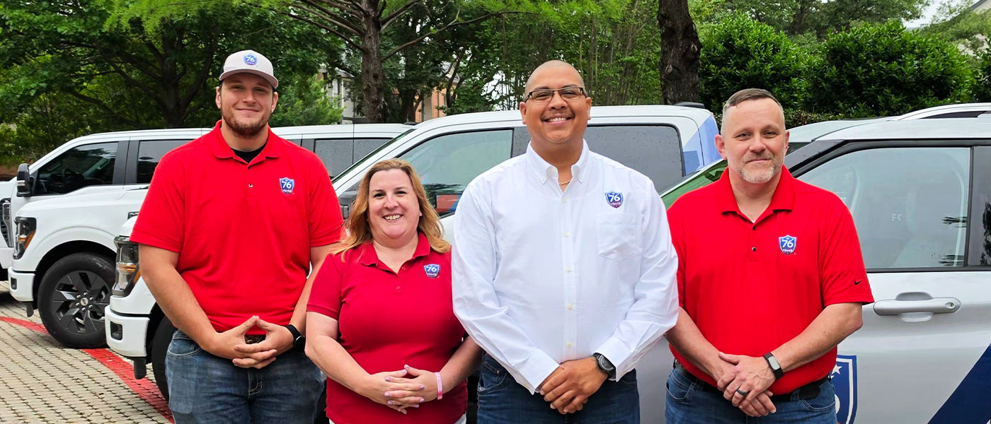 76 Fence DFW owners standing by a truck, provided by our fencing company.