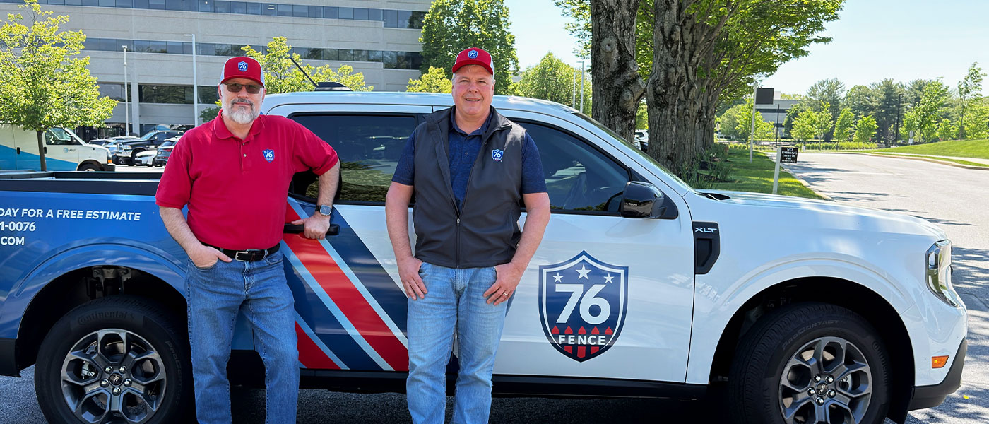 76 Fence MontCo owners standing by a truck, provided by our fencing company.
