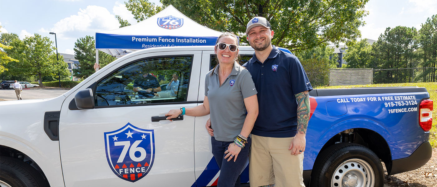 76 Fence RDU West owners standing by a truck, provided by our fencing company.